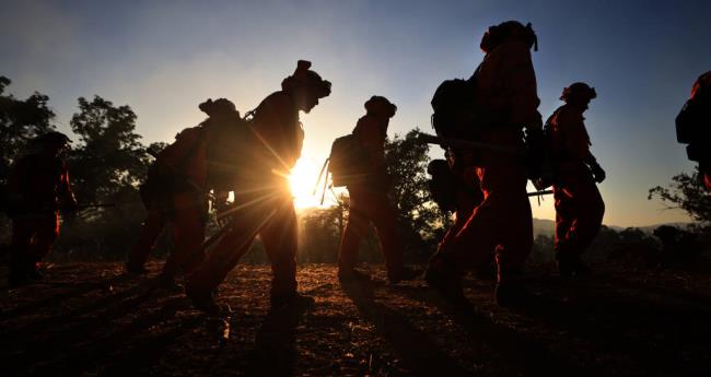 Two inmate firefighters walk to the Creek Fire to cut line in Lower Lake, Wednesday, Sept. 6, 2023. (Kent Porter / The Press Democrat file)