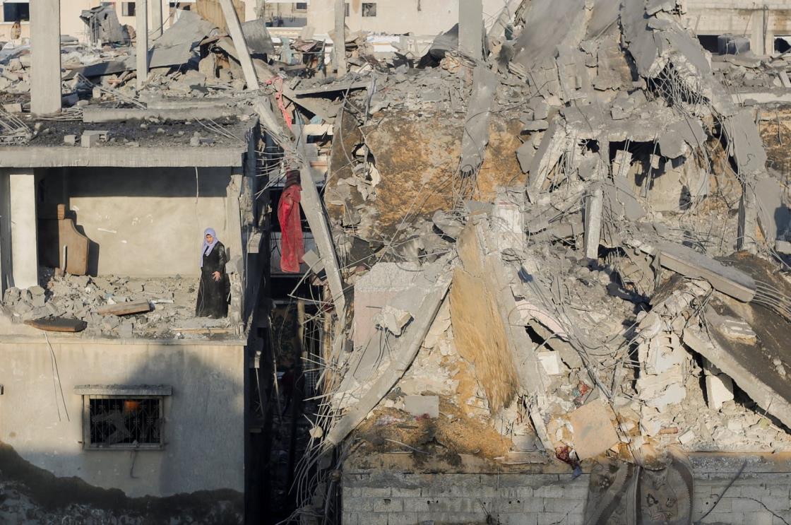 A Palestinian woman stands in a destroyed room in a building as she inspects the site of Israeli strikes, in Khan Younis, southern Gaza Strip, Palestine, Dec. 6, 2023. (Reuters Photo)